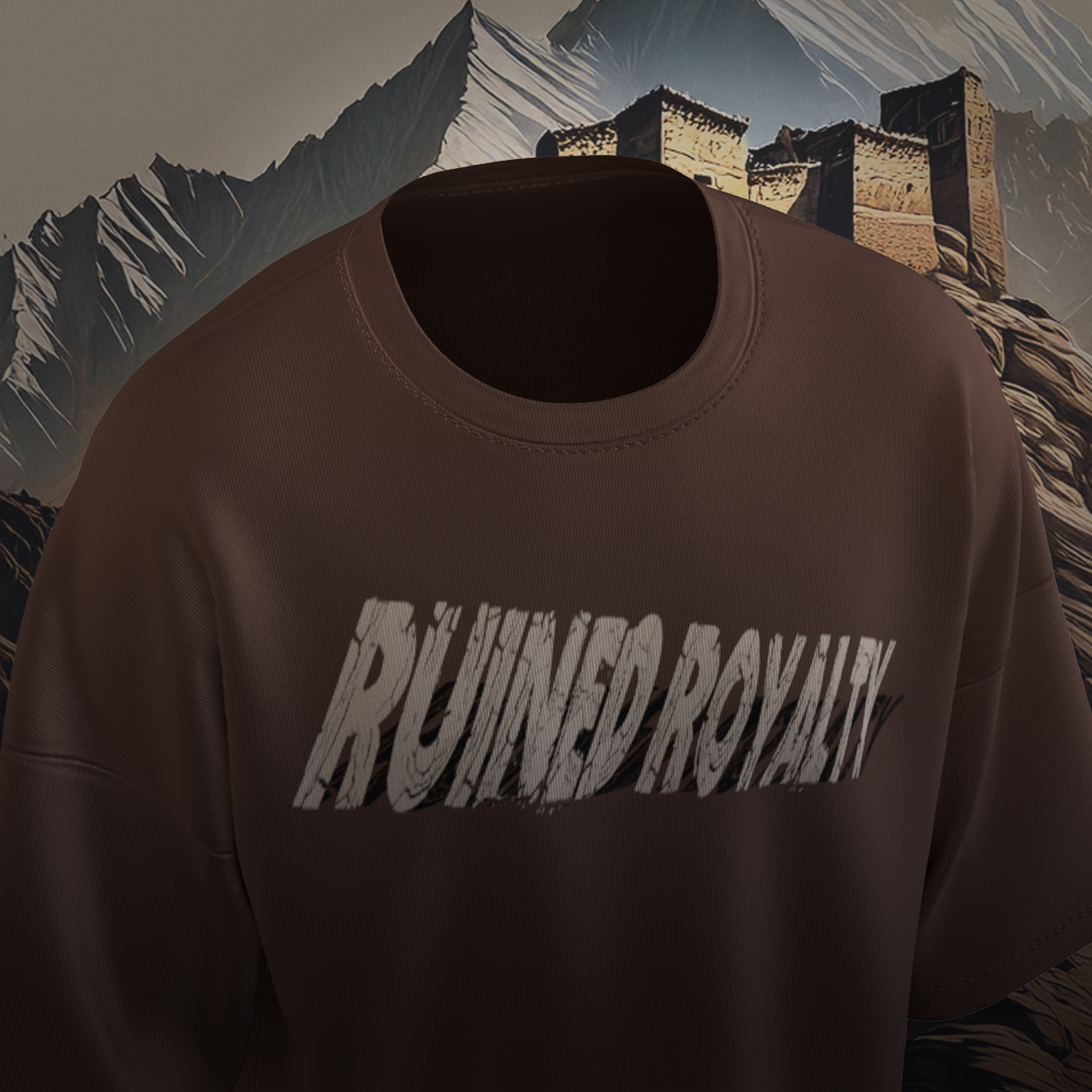 Brown oversized t-shirt with 'RUINED ROYALTY' text against a mountainous background