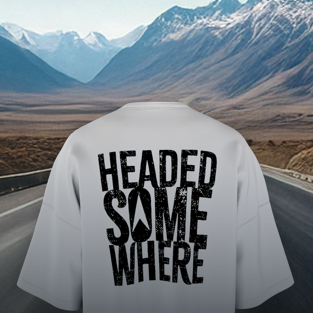 White Oversized T-shirt with 'HEADED SOMEWHERE' text on a scenic mountain road background