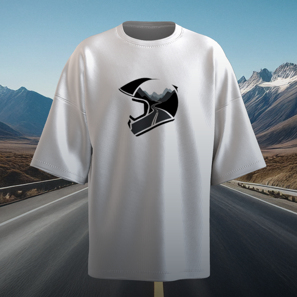 White oversized t-shirt with a black and white helmet graphic on a scenic road background