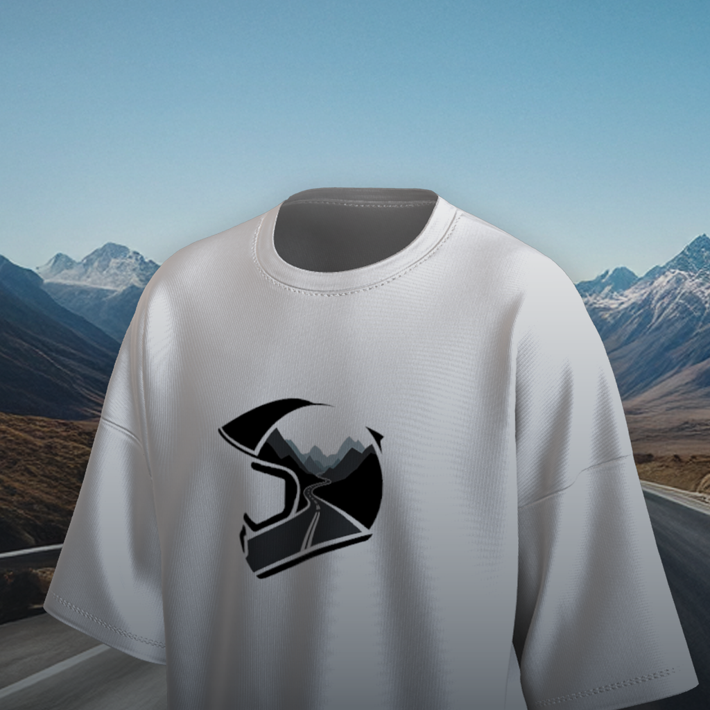 White oversized t-shirt with a black helmet graphic on a scenic mountain road background