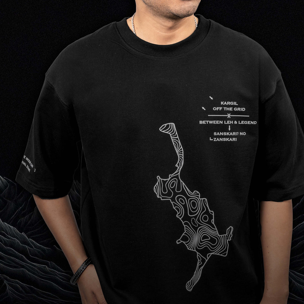 Oversized T-shirt featuring contour-map artwork and graphic text, perfect for streetwear enthusiasts.
