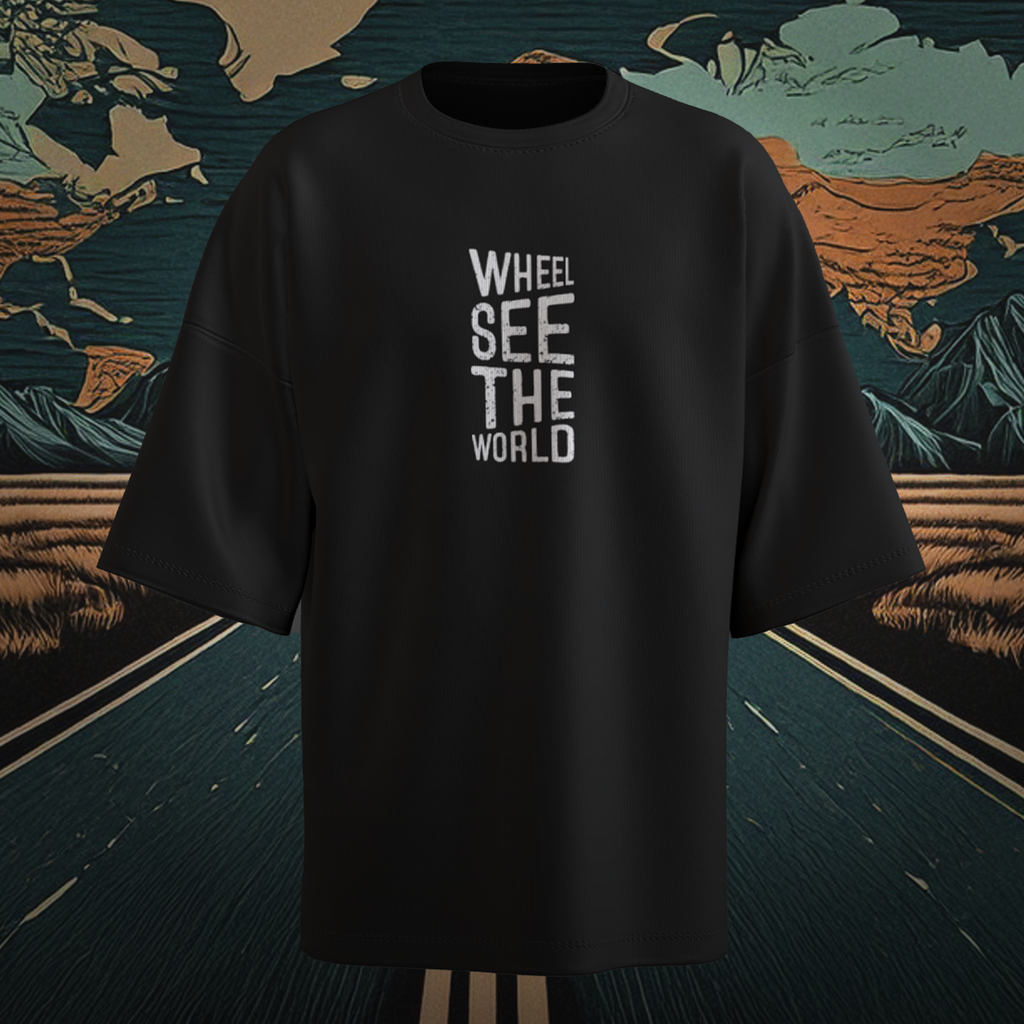 Black oversized t-shirt with 'WHEEL SEE THE WORLD' text on a decorative background