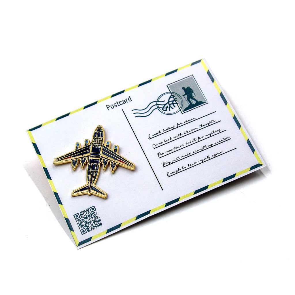 Postcard with airplane pin on a white background