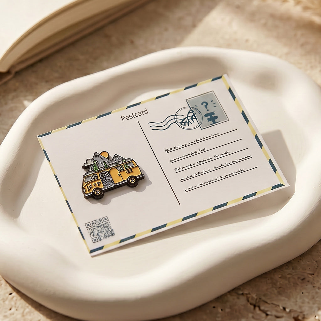Postcard with a vehicle-shaped pin on a beige surface