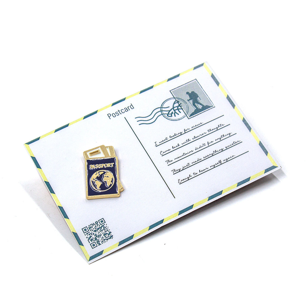 Postcard with passport-shaped magnet on a white background