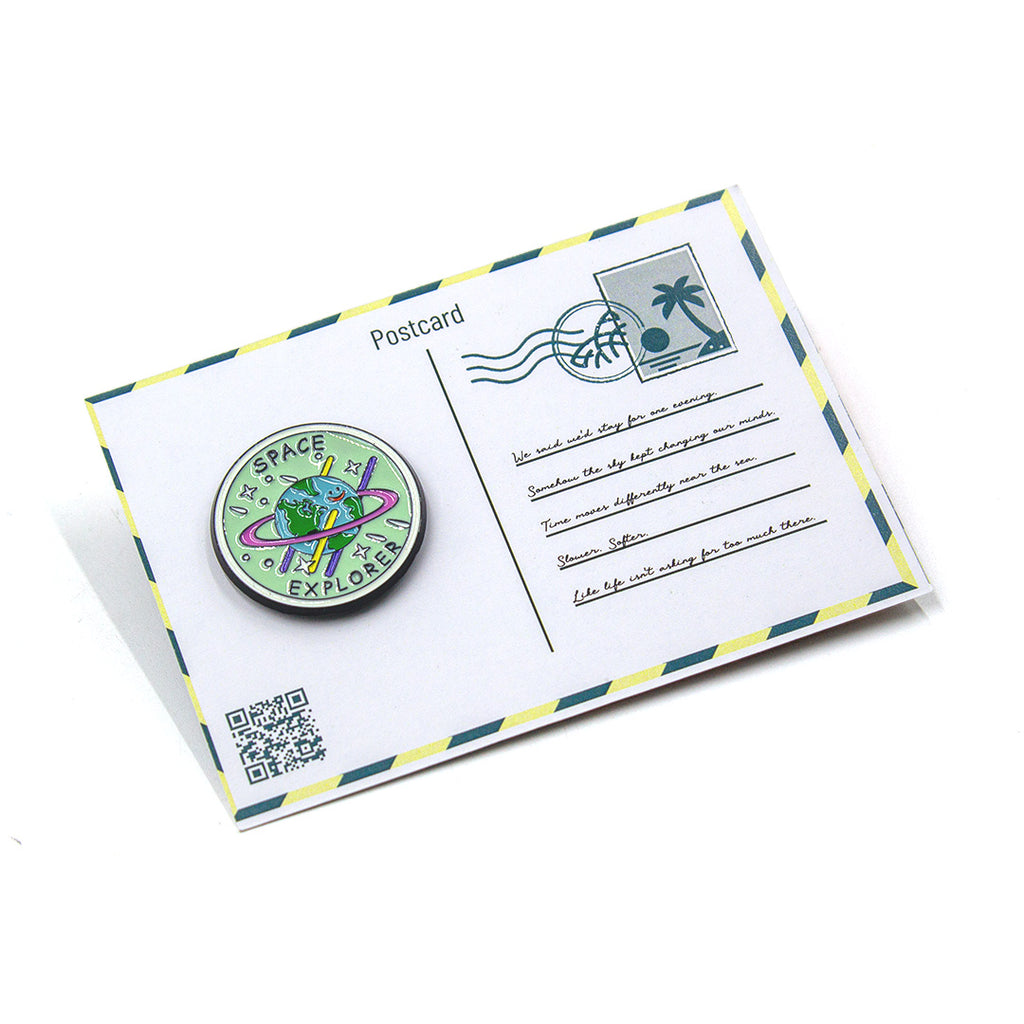 Postcard with a space-themed button badge on a white background