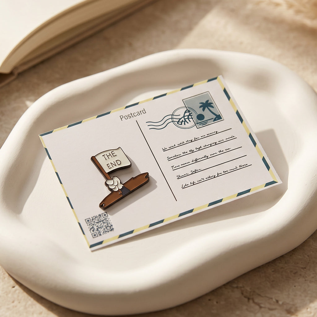 Wooden book-shaped pin on a postcard with a stamp on a beige surface