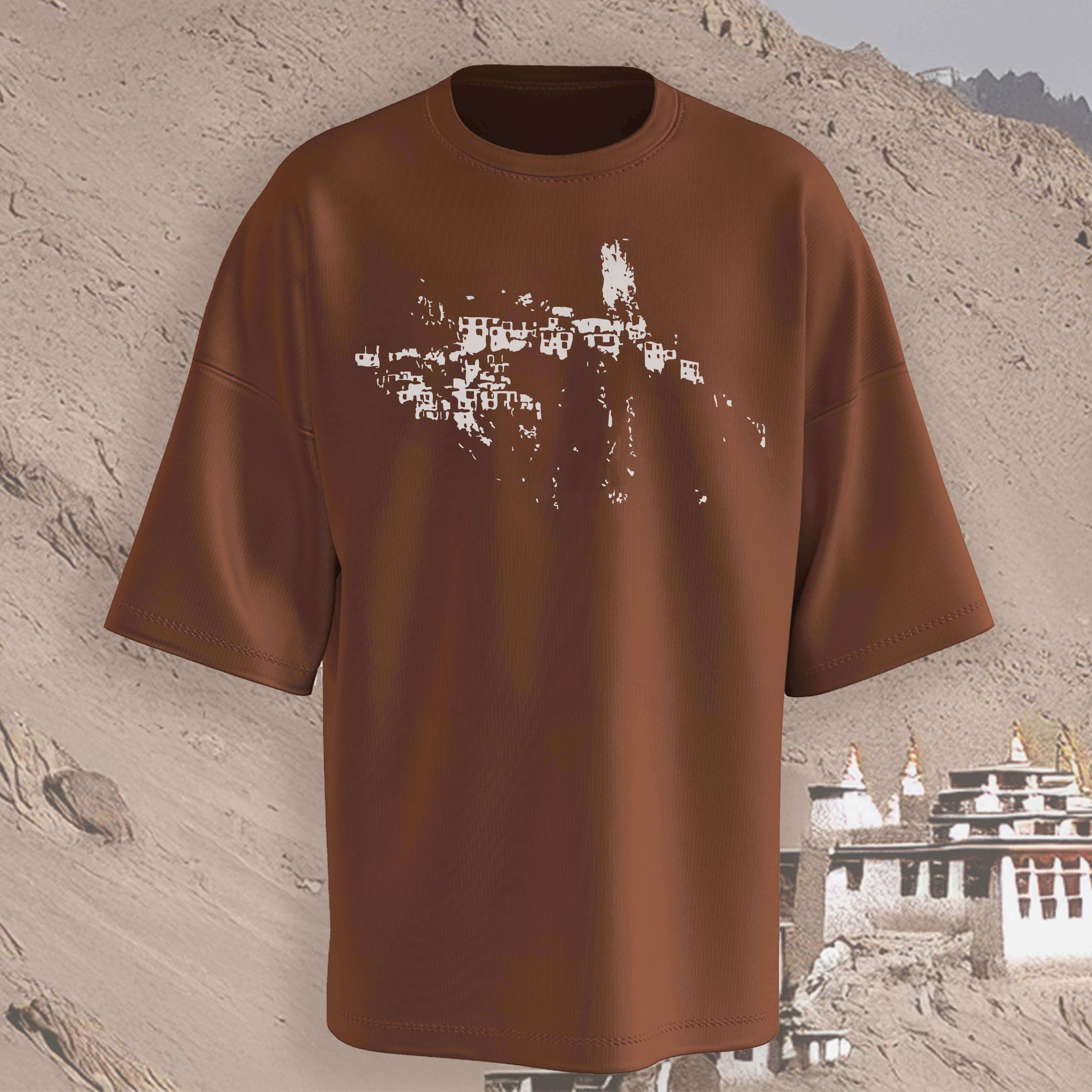Leh Brown oversized t-shirt with a graphic design on a textured beige background