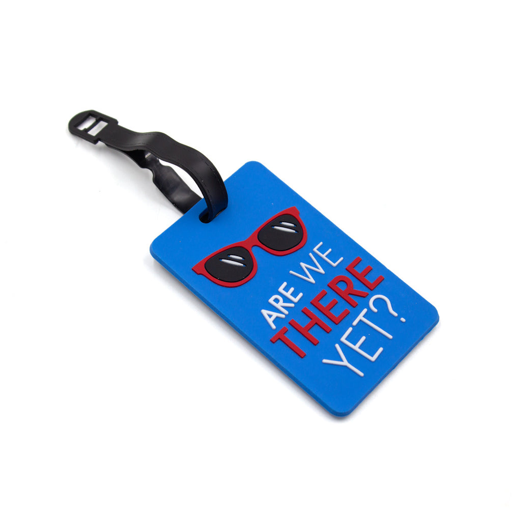 Blue luggage tag with sunglasses graphic and text 'Are we there yet?' on a white background