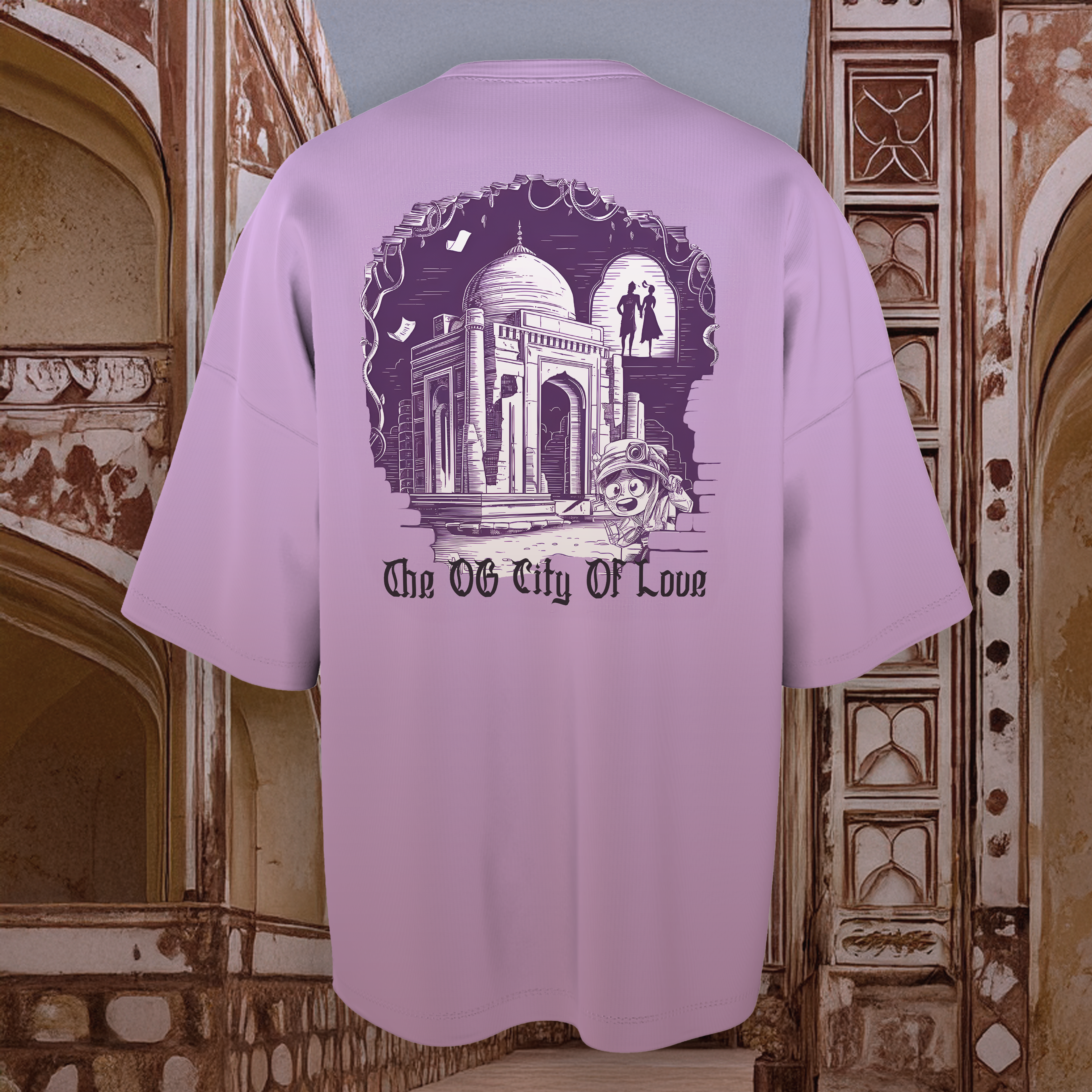 Lavender oversized  t-shirt with architectural design and text 'The OG City Of Love' against a decorative wall background