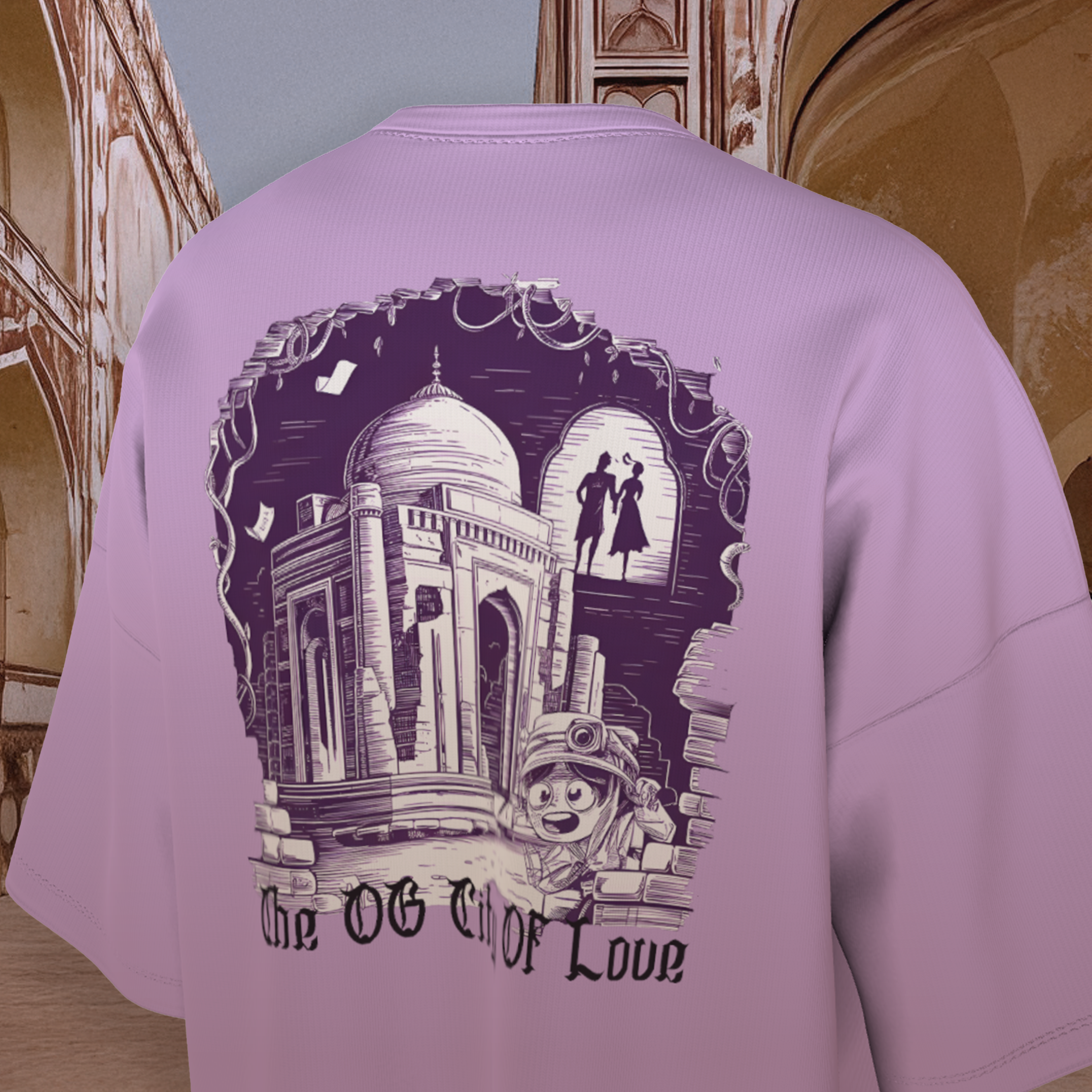Lavender oversized  t-shirt with a graphic design on the back, featuring a couple and text, against a architectural background.