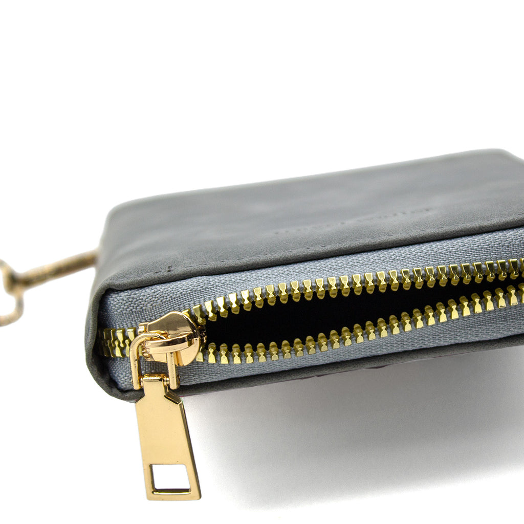 Gray clutch with gold zipper on a white background