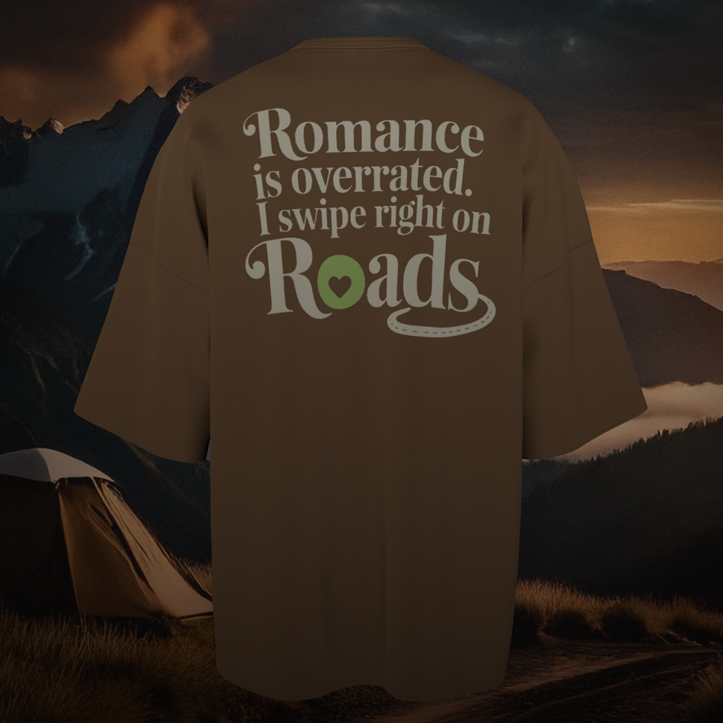 Brown Oversized T-shirt with 'Romance is overrated. I swipe right on Roads' text against a mountainous landscape.