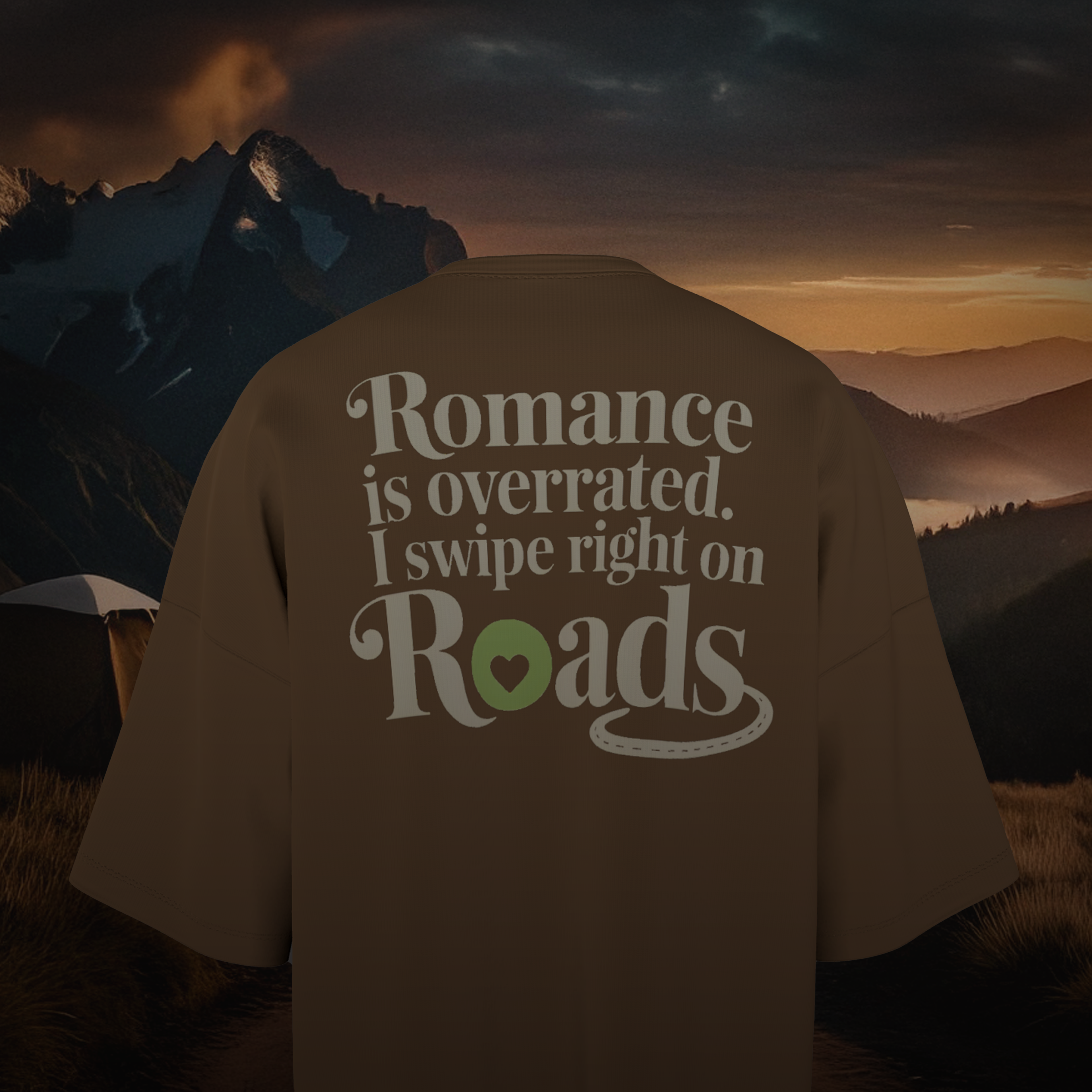 Brown Oversized t-shirt with 'Romance is overrated. I swipe right on Roads' text against a mountainous landscape.