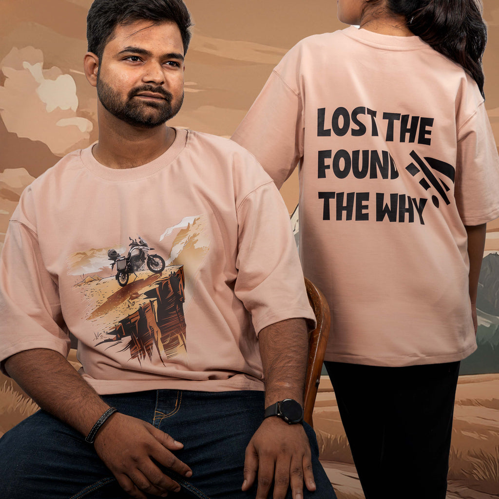 Two people wearing lost the wifi beige oversized t-shirts with a desert-themed design and text.