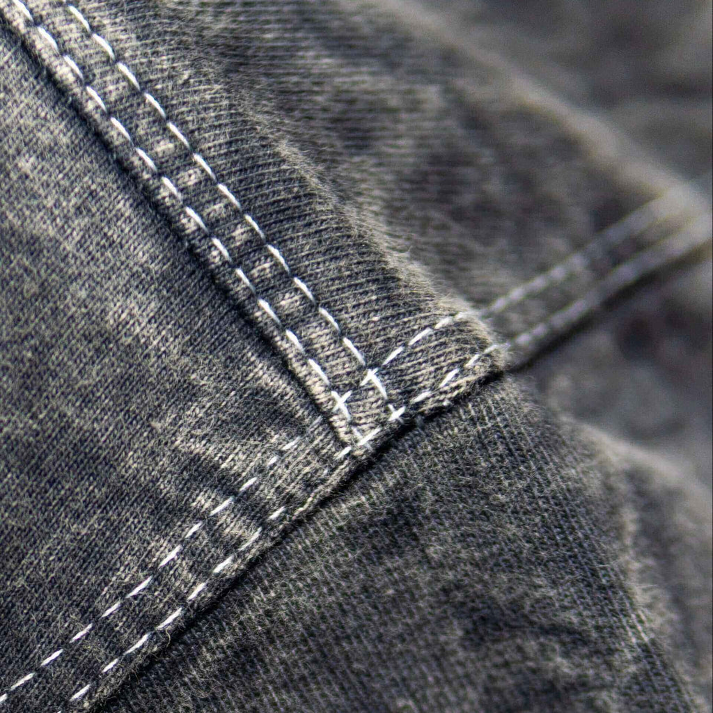 Close-up of acid wash fabric with visible stitching